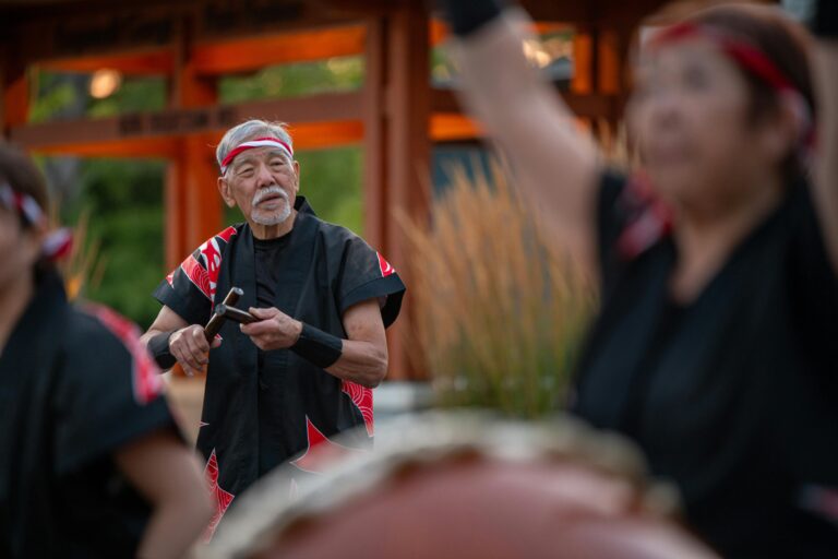 Elderly man performing traditional Taiko drum music at a cultural festival in Victoria, BC.