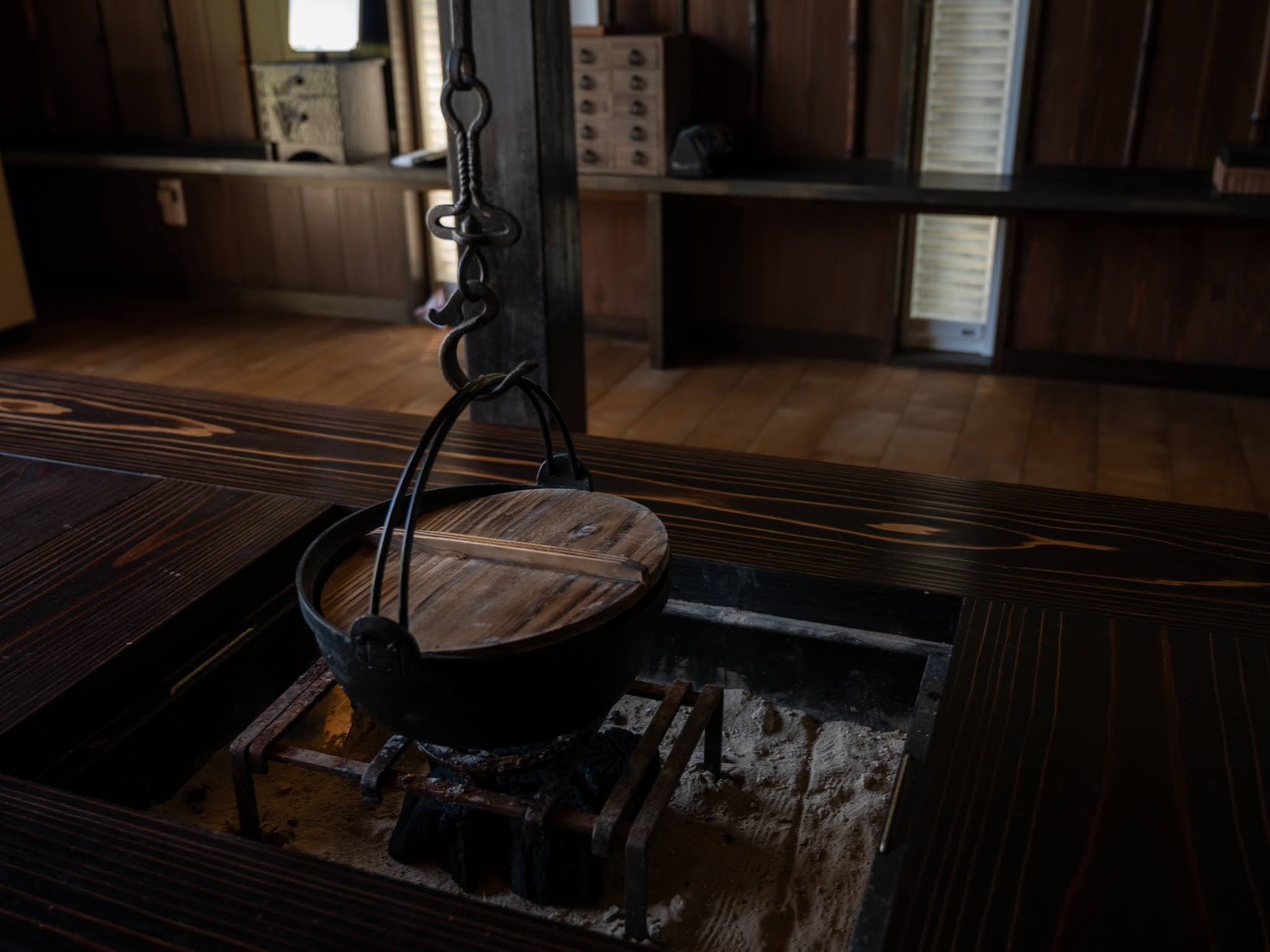 The irori hearth with hand-forged iron chain and cast iron pot