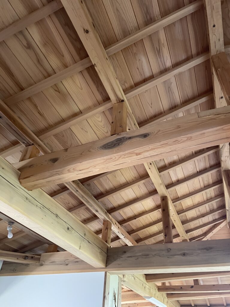 Exposed wood beam joints in a traditional Japanese timber-frame roof structure